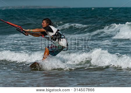 Kitesurfing on the waves of the sea in Mui Ne beach, Phan Thiet, Binh Thuan, Vietnam. Kitesurfing, Kiteboarding action photos Kitesurfer In action