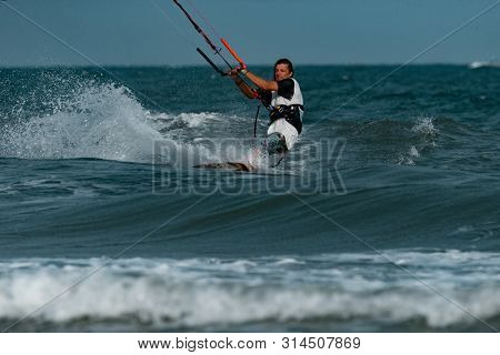 Kitesurfing on the waves of the sea in Mui Ne beach, Phan Thiet, Binh Thuan, Vietnam. Kitesurfing, Kiteboarding action photos Kitesurfer In action