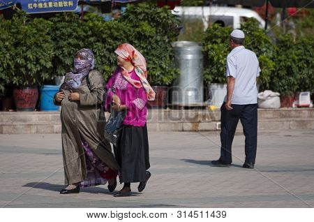 Kashgar, Xinjiang, China - August 14, 2012: Two Uyghur Women At A Street In The City Of Kashgar, Xin
