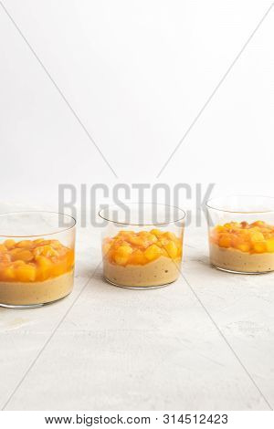 Caramel Panna Cotta, Custard Pudding With Peach And Passion Fruit, White Table, Copy Space