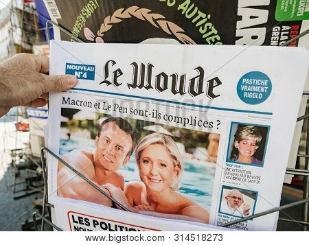 Paris, France - Jul 24, 2019: Man Hand Holding Satirical Le Woude Newspaper At French Press Kiosk Wi