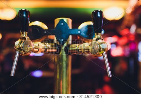 Close Up Of Beer Taps In Row. Metallic Equipment For Bars And Mini Brewerys. Concept Of Modern Equip