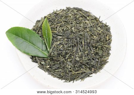 Dried Tea Leaves With Green Tea Leaves Isolated On White Background
