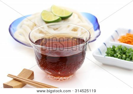 Japanese Chilled Udon Noodles In A Glass Plate With Mentuyu On White Background