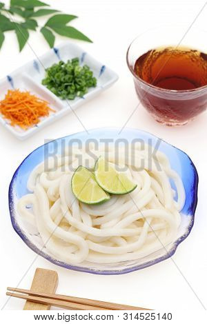 Japanese Chilled Udon Noodles In A Glass Plate With Mentuyu On White Background