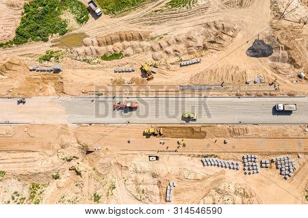 Roadrollers And Grader Flattening The Ground Before Road Construction. Aerial View