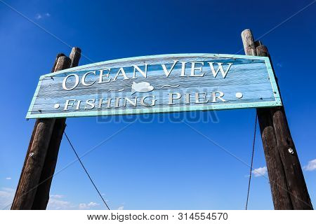 Norfolk, Virginia/usa - July 22, 2019:  Entrance Sign For The Ocean View Fishing Pier, Which Stretch