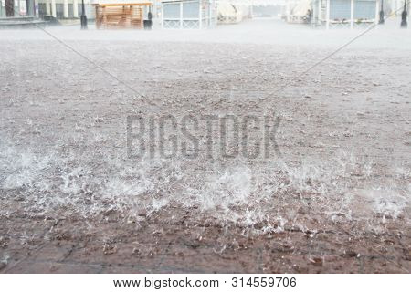 Heavy Rain In The City. Town Square. Close Up Sidewalk With Rectangle Tiles Under Water.