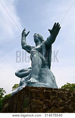 Nagasaki, Japan - 25 May 2013, Peace Park With Peace Statue. The Statue Is Commemorating The Atomic 