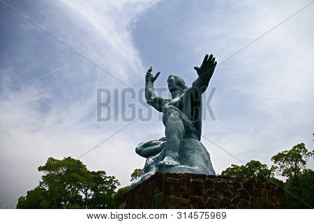 Nagasaki, Japan - 25 May 2013, Peace Park With Peace Statue. The Statue Is Commemorating The Atomic 