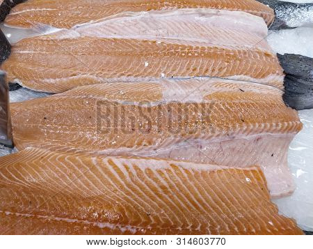 Fresh Salmon, Fillet And Whole, On Ice Display In Supermarket