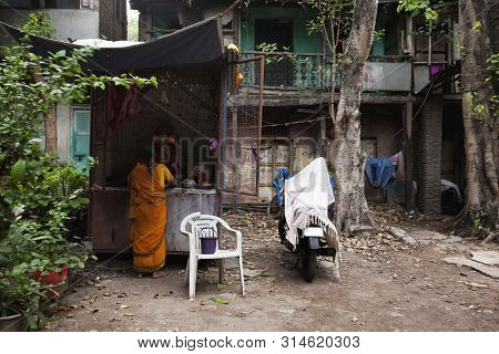 Pune, India, March 2012, Woman Praying To Lord Ganesha Near Old Building In Wadas