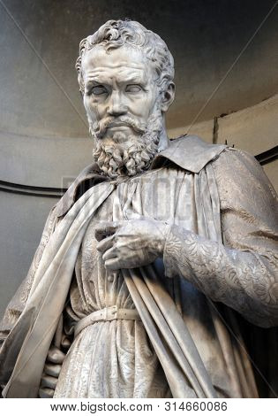 FLORENCE, ITALY - JANUARY 11, 2019: Michelangelo Buonarroti, statue in the Niches of the Uffizi Colonnade in Florence, Italy