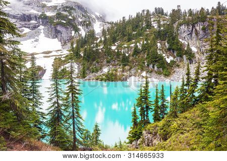Serenity lake in the mountains in summer season. Beautiful natural landscapes.