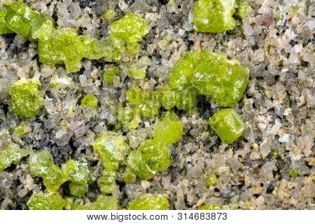 Closeup Of A Peridot Or Olivin Mineral Stone Pattern Background, Details And Macro Of Mineralogy