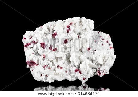 Raw Cinnabar Or Cinnabarite Mineral Stone In Front Of Black Background, Mineralogy And Pigments