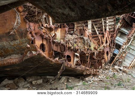 Huge Rusty Pieces Of Decommissioned Marine Ship That Was Cut And Left On The Shore.