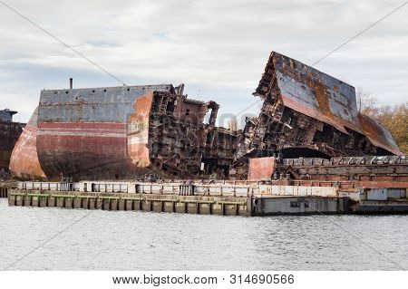 Huge Rusty Pieces Of Decommissioned Marine Ship That Was Cut And Left On The Shore.
