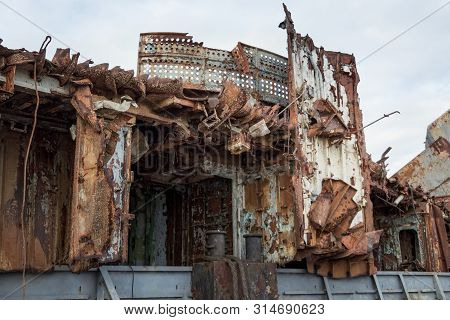 Huge Rusty Pieces Of Decommissioned Marine Ship That Was Cut And Left On The Shore.