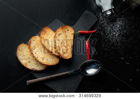 Toast The Bread On A Black Slate, Next Is Red Pepper.