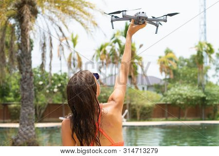 Female Launches A Drone For Flight, With Which You Can Take Photos And Videos, Near The Swimming Poo