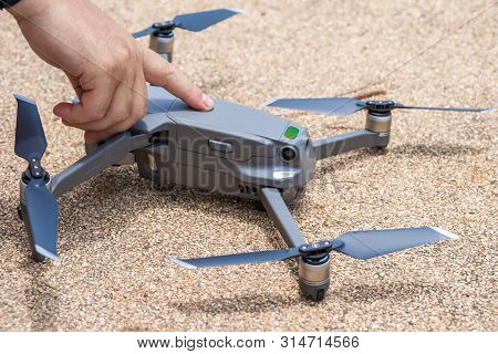 Male Finger Presses The Launch Button Of The Drone For Flight, With Which You Can Take Photos And Vi