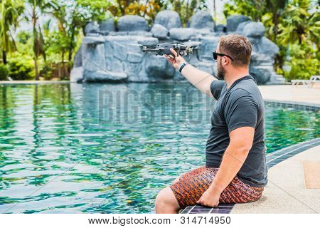 Bearded Man Launches Drone For Flight, With Which You Can Take Photos And Video Filming, Near The Sw