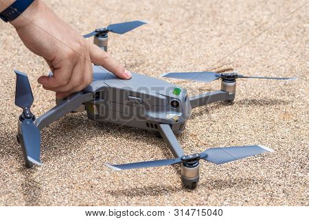 Male Finger Presses The Launch Button Of The Drone For Flight, With Which You Can Take Photos And Vi