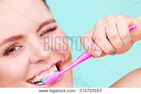 Woman Brushing Cleaning Teeth. Girl With Toothbrush Close Up. Oral Hygiene. Blue Green Background