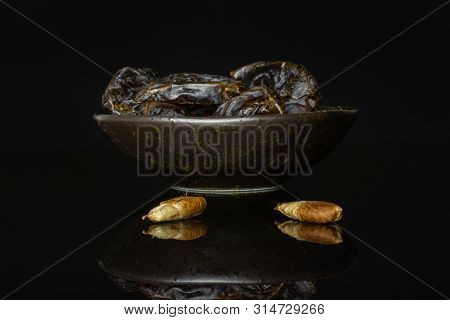 Group Of Lot Of Whole Two Halves Two Pieces Of Dried Brown Date Medjool On Grey Ceramic Plate Isolat