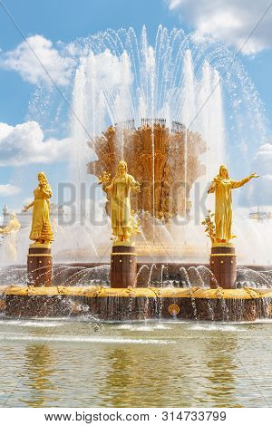 Moscow, Russia - July 22, 2019: Gilded Figures Of Friendship Of Peoples Fountain Under The Water Jet