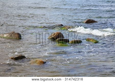 Big Stones In The Sea Water Near The Shore.