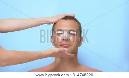Plastic Surgery Concept, Hands Holding A Mans Face. A Man After A Plastic Surgery On The Face, Rhino