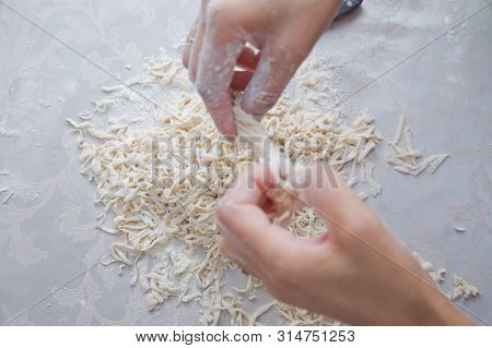 Cutting Long Dough Stripe For Cooking Pasta. Homemade Food Preparation Concept. Closeup Of Process O