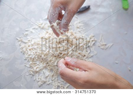 Cutting Long Dough Stripe For Cooking Pasta. Homemade Food Preparation Concept. Closeup Of Process O