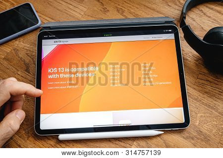 Paris, France - Jun 6, 2019: Man Reading On Apple Ipad Pro Tablet About Latest Announcement Of At Ap