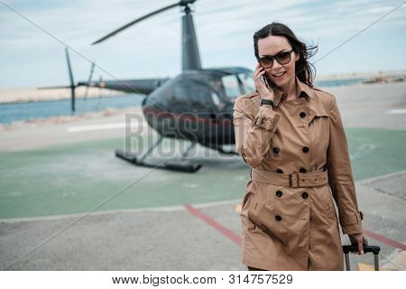 Business woman near private a helicopter