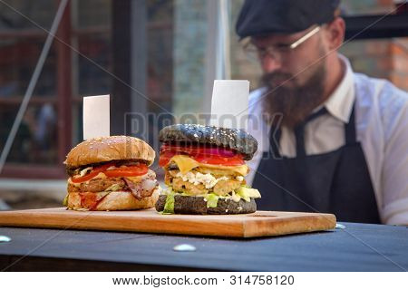 Kiev, Ukriane - August 2015: Festival Street Food. Two Hamburger Stand On The Board With Tags. In Th