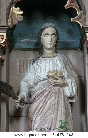 LIJEVI DUBROVCAK, CROATIA - SEPTEMBER 26, 2011: Saint Dorothea of Alexandria, statue on the altar of the Holy Family in the church of the Saint Nicholas in Lijevi Dubrovcak, Croatia
