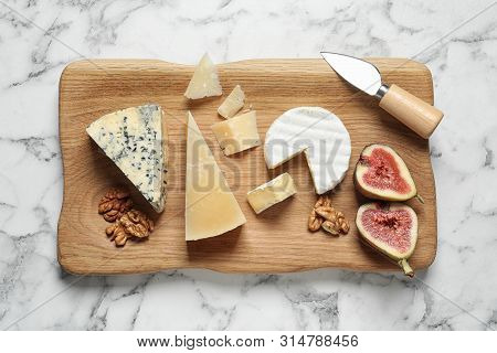 Different Delicious Cheeses Served On Marble Table, Top View