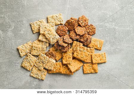 Salted crispy crackers on old kitchen table.