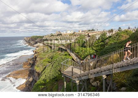 Sydney, Australia - June 20th 2015: A Female Jogger Runs Up Steps On The Eastern Beaches Coastal Pat