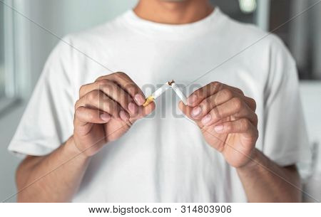 Stop Smoking Cigarettes Concept. Portrait Of Beautiful  Holding Broken Cigarette In Hands. Happy , H