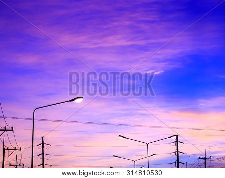 Fantasy Sky Background With Pink Clouds And Highlight Of Streetlight After Sunset In Winter