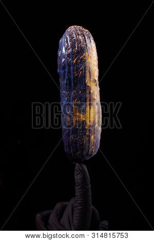 Beautiful Bright Eclair With Blets On A Dark Background.