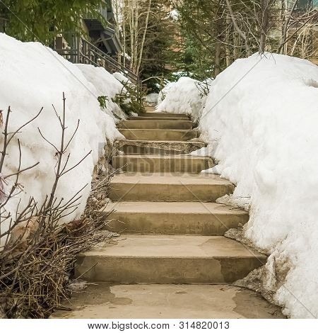Square Frame Weathered Concerete Outdoor Steps Amid Snow Covered Slope In Winter