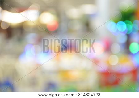 Atmosphere Of Amusement Park In Shopping Mall With Boken Lights Blur Background,use For Backdrop Or 