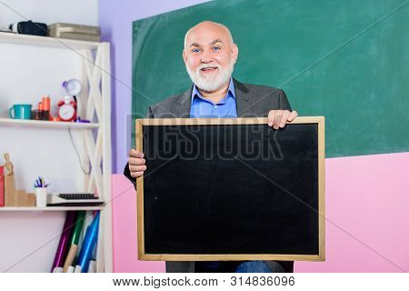 Back To School. Education Concept. Place For Copy Space. Mature Teacher Man Hold Chalk Board. Inform