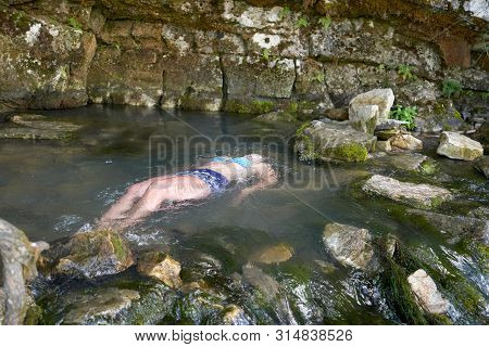 Woman Drowned In A Mountain River, Drowned In Water
The Corpse Of A Girl In Shorts And A Bra In The 