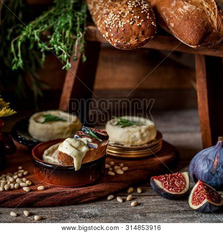 Soft Spreadable French Stinky Cheese On A Slice Of Bread With Fruit And Pine Nuts, Square